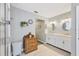 Bright bathroom featuring double sinks, and a tiled walk-in shower at 6911 Stetson Street Cir, Sarasota, FL 34243