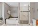 Elegant bathroom boasts a soaking tub, glass-enclosed shower, and stylish decor at 6911 Stetson Street Cir, Sarasota, FL 34243