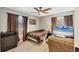 Relaxing bedroom featuring a comfortable bed, a flat-screen TV, and natural light from the windows at 6911 Stetson Street Cir, Sarasota, FL 34243
