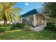 Exterior of community center with picnic tables, a grill, and lush landscaping at 6911 Stetson Street Cir, Sarasota, FL 34243
