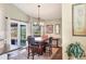 Charming dining area features stylish chandelier, wood floors, and sliding glass doors to the lanai at 6911 Stetson Street Cir, Sarasota, FL 34243