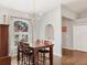 Dining area features dark wood furniture and floors, with a large window providing lots of natural light at 6911 Stetson Street Cir, Sarasota, FL 34243