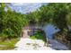 Community boat dock with wooden platform offers access to the waterway, surrounded by lush greenery at 6911 Stetson Street Cir, Sarasota, FL 34243