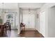 Welcoming entryway featuring wood-look floors and a view into the adjacent dining and living spaces at 6911 Stetson Street Cir, Sarasota, FL 34243