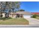 Charming single-story home featuring a manicured lawn, inviting entrance and attached two car garage at 6911 Stetson Street Cir, Sarasota, FL 34243