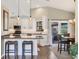 Bright kitchen featuring granite countertops, stainless steel appliances, and an adjacent dining area at 6911 Stetson Street Cir, Sarasota, FL 34243