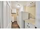 Well-lit laundry room with white cabinets, a countertop, and a washing machine and dryer at 6911 Stetson Street Cir, Sarasota, FL 34243