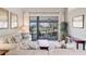 Bright living room featuring neutral décor and a screened lanai, creating a cozy and inviting space at 6911 Stetson Street Cir, Sarasota, FL 34243