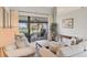 Inviting living room featuring neutral decor with sliding glass doors to screened patio and natural light at 6911 Stetson Street Cir, Sarasota, FL 34243