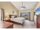 Inviting main bedroom featuring vaulted ceiling, plush carpet, and view of the backyard at 6911 Stetson Street Cir, Sarasota, FL 34243
