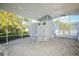 Screened-in patio features a tile floor, ceiling fans, and an outdoor dining table, perfect for Florida living at 6911 Stetson Street Cir, Sarasota, FL 34243