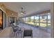 Inviting screened-in patio with comfortable seating and views of the lush backyard and greenery at 6911 Stetson Street Cir, Sarasota, FL 34243