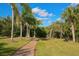 Scenic community walking path with trees and benches to enjoy nature at 6911 Stetson Street Cir, Sarasota, FL 34243