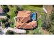 Aerial view of a tile roof home with mature landscaping, pool and surrounding community at 6919 Winners Cir, Lakewood Ranch, FL 34202