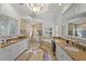 An amazing bathroom showcasing granite countertops, glass shower, soaking tub and decorative chandelier at 6919 Winners Cir, Lakewood Ranch, FL 34202