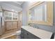 Bathroom featuring a walk-in glass shower, large mirror, and granite vanity at 6919 Winners Cir, Lakewood Ranch, FL 34202