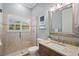 Bright bathroom with glass enclosed shower, large mirror and granite vanity at 6919 Winners Cir, Lakewood Ranch, FL 34202