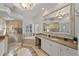 An amazing bathroom showcasing granite countertops, glass shower, soaking tub and decorative chandelier at 6919 Winners Cir, Lakewood Ranch, FL 34202