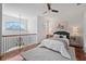 Bright bedroom boasts hardwood floors, a ceiling fan, a decorative window and a serene accent wall art piece at 6919 Winners Cir, Lakewood Ranch, FL 34202