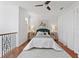 Upstairs bedroom with light grey rug, king bed, and hardwood floors at 6919 Winners Cir, Lakewood Ranch, FL 34202