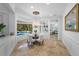 Elegant dining area with views of the pool, modern chandelier, and seamless access to other living spaces at 6919 Winners Cir, Lakewood Ranch, FL 34202