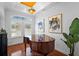 Dining room with hardwood floors, elegant chandelier, and natural light at 6919 Winners Cir, Lakewood Ranch, FL 34202
