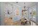 Elegant dining area with modern chandelier and direct access to the pool area at 6919 Winners Cir, Lakewood Ranch, FL 34202