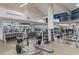 A fitness center with various exercise machines, free weights, mirrors and tv for entertainment at 6919 Winners Cir, Lakewood Ranch, FL 34202