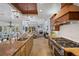 Bright kitchen with stainless steel appliances, spacious island and open floor plan to living room at 6919 Winners Cir, Lakewood Ranch, FL 34202