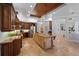 Open kitchen boasts wood cabinets, stainless steel appliances, tile flooring and a large island at 6919 Winners Cir, Lakewood Ranch, FL 34202