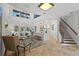 Bright living room with high ceilings, travertine floors, staircase, and seamless access to other living spaces at 6919 Winners Cir, Lakewood Ranch, FL 34202