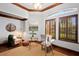 Charming office with custom trim, lots of light, and a cozy seating area at 6919 Winners Cir, Lakewood Ranch, FL 34202