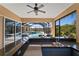 Outdoor kitchen with granite countertops, built-in grill, sink, and screened views of the pool and backyard at 6919 Winners Cir, Lakewood Ranch, FL 34202