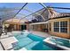 Amazing screened-in pool features hot tub, outdoor kitchen and seating area with expansive views of the backyard at 6919 Winners Cir, Lakewood Ranch, FL 34202