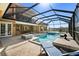 Gorgeous screened-in pool with outdoor seating, spa, and lake views offers the ultimate outdoor relaxation at 6919 Winners Cir, Lakewood Ranch, FL 34202