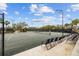 A community tennis court with new lighting, new fencing, and seating for spectators at 6919 Winners Cir, Lakewood Ranch, FL 34202