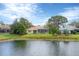 Lovely backyard view from the water, complete with a screened-in lanai and mature landscaping at 8116 Collingwood Ct, University Park, FL 34201