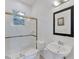 Bright bathroom with glass enclosed shower, standard toilet, and decorative mirror above sink at 8116 Collingwood Ct, University Park, FL 34201