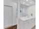 Bright bathroom with white cabinetry, a large mirror, and access to an adjacent room at 8116 Collingwood Ct, University Park, FL 34201