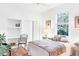 Cozy bedroom featuring a built-in desk, plush bedding, and a serene window view at 8116 Collingwood Ct, University Park, FL 34201