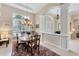 Formal dining room with chandelier lighting and decorative columns at 8116 Collingwood Ct, University Park, FL 34201