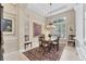 Formal dining room with chandelier lighting and large window at 8116 Collingwood Ct, University Park, FL 34201