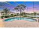 Screened-in pool area with an in-ground pool and views of the lake at 8116 Collingwood Ct, University Park, FL 34201