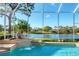 Screened pool with relaxing waterfall feature overlooking a serene lake and lush golf course at 8116 Collingwood Ct, University Park, FL 34201