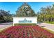 University Park community entrance featuring a lush garden and manicured landscaping at 8121 Collingwood Ct, University Park, FL 34201