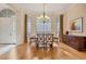 Formal dining room with wood floors, chandelier, buffet, and bay window at 8121 Collingwood Ct, University Park, FL 34201