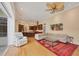 Open floor plan connecting the living room and kitchen, with hardwood floors and a seamless flow at 8121 Collingwood Ct, University Park, FL 34201