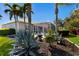Backyard with a manicured lawn, mature landscaping, and screened in lanai at 8803 18Th Nw Ave, Bradenton, FL 34209
