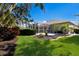 Backyard with a manicured lawn, screened in lanai and mature landscaping at 8803 18Th Nw Ave, Bradenton, FL 34209