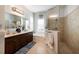 Bathroom with a double vanity, large mirror, soaking tub, and glass-enclosed shower at 8803 18Th Nw Ave, Bradenton, FL 34209
